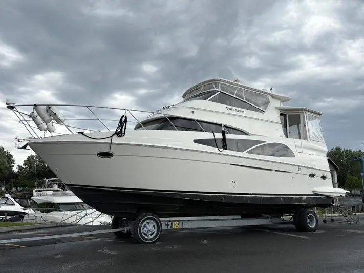 Odyssea II Yacht Photos Pics 2009 Carver 46 Motor Yacht on trailer under cloudy sky.
