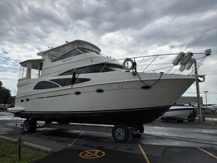 Odyssea II Yacht Photos Pics 2009 Carver 46 Motor Yacht on trailer under cloudy sky.