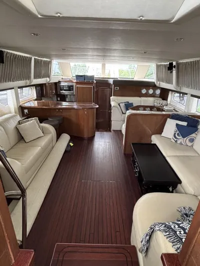 Odyssea II Yacht Photos Pics Luxurious interior of 2009 Carver 46 Motor Yacht with elegant seating and wood finishes.