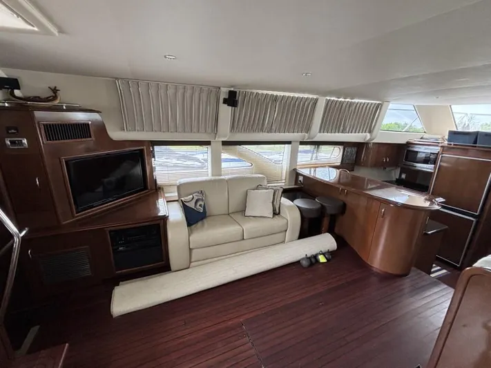 Odyssea II Yacht Photos Pics Luxurious interior of 2009 Carver 46 Motor Yacht with sofa, TV, and kitchenette.
