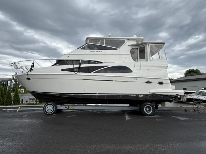 Odyssea II Yacht Photos Pics 2009 Carver 46 Motor Yacht on trailer under cloudy sky.