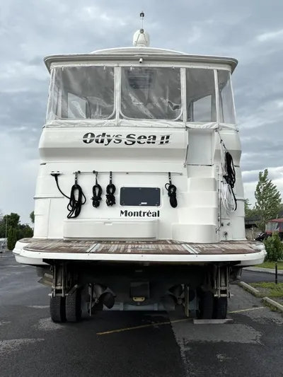 Odyssea II Yacht Photos Pics 2009 Carver 46 Motor Yacht, rear view, docked, with "Ody Sea II" and "Montréal" text.