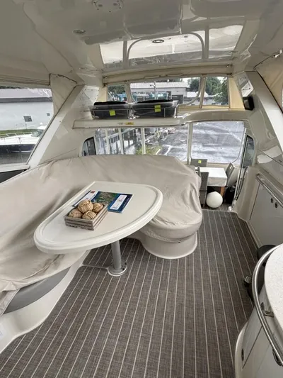 Odyssea II Yacht Photos Pics 2009 Carver 46 Motor Yacht interior with seating, table, and panoramic windows.