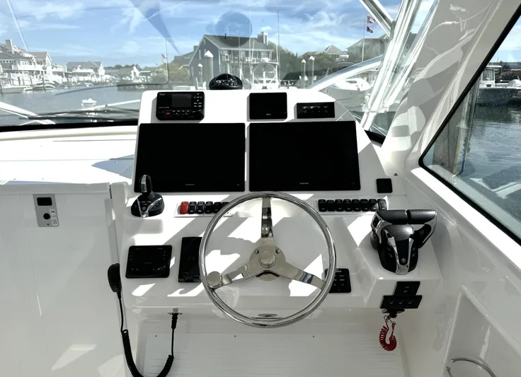  Yacht Photos Pics 2022 Albemarle 30 Express helm with modern navigation equipment and steering wheel.