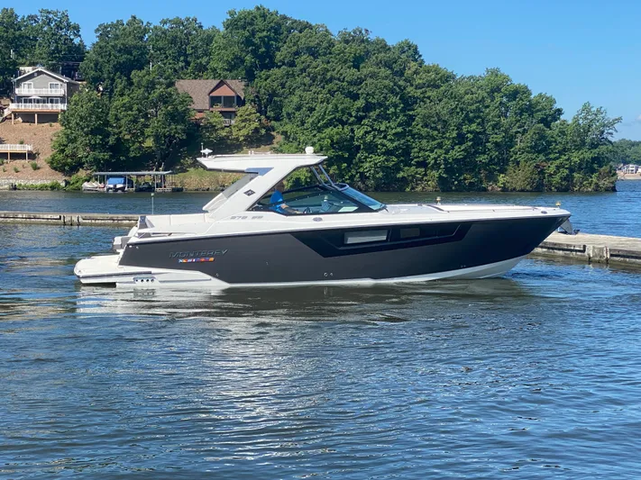  Yacht Photos Pics 2022 Monterey 378SS boat on a lake with lush green trees in the background.