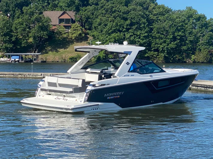  Yacht Photos Pics 2022 Monterey 378SS boat cruising on a lake with lush green shoreline.
