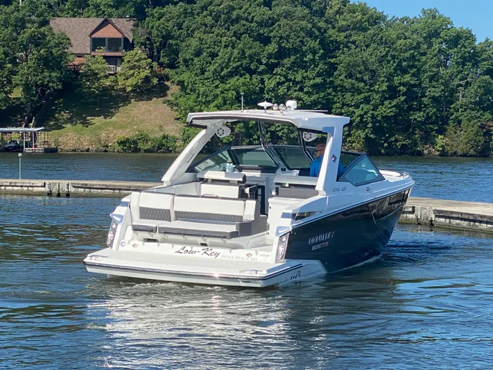  Yacht Photos Pics 2022 Monterey 378SS boat on a lake near a wooded shoreline.