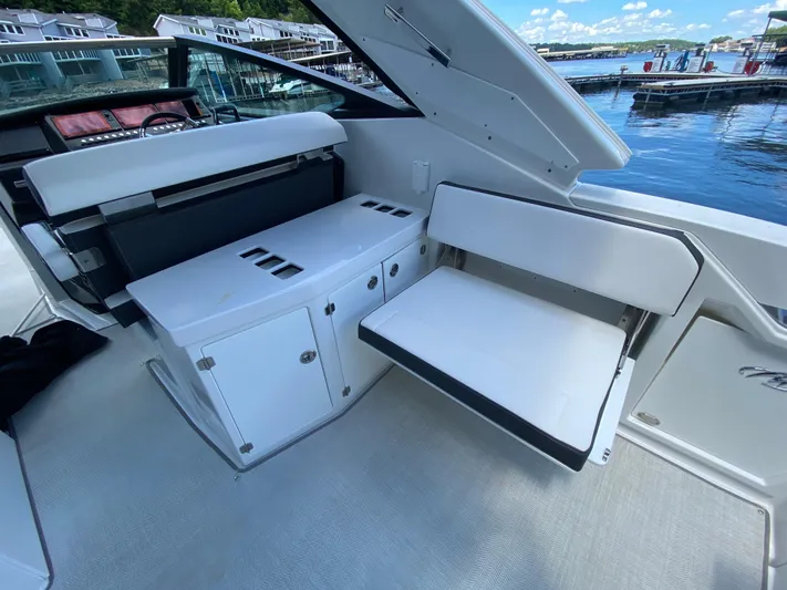  Yacht Photos Pics 2022 Monterey 378SS boat interior with white seating and storage, dockside view.