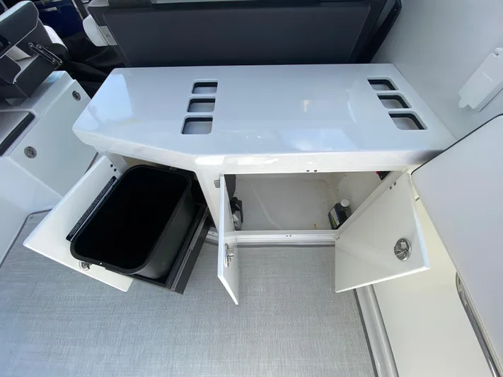  Yacht Photos Pics 2022 Monterey 378SS boat interior storage compartments with open doors and trash bin.