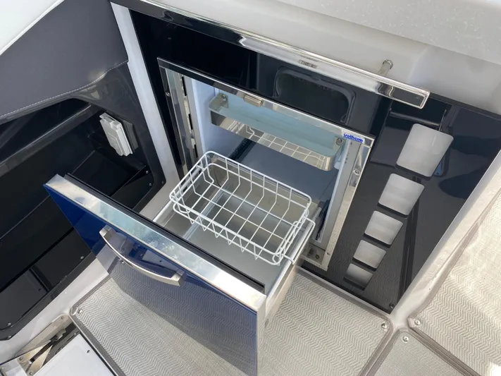  Yacht Photos Pics Open refrigerator on 2022 Monterey 378SS boat, featuring a wire basket and sleek design.