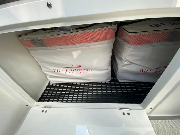  Yacht Photos Pics Storage compartment with life jackets on a 2022 Monterey 378SS boat.