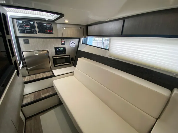  Yacht Photos Pics Interior of 2022 Monterey 378SS boat with modern seating and control panels.