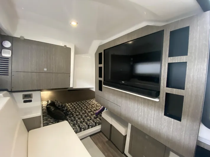  Yacht Photos Pics 2022 Monterey 378SS cabin interior with TV, bed, and modern cabinetry.