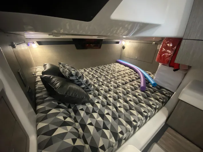  Yacht Photos Pics Interior cabin of 2022 Monterey 378SS boat with geometric bedding and pool noodles.