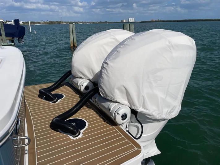  Yacht Photos Pics 2023 Regulator 31 boat with covered outboard motors on a sunny day.