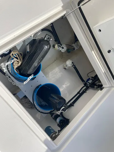  Yacht Photos Pics 2023 Regulator 31 boat storage compartment with equipment and ropes.