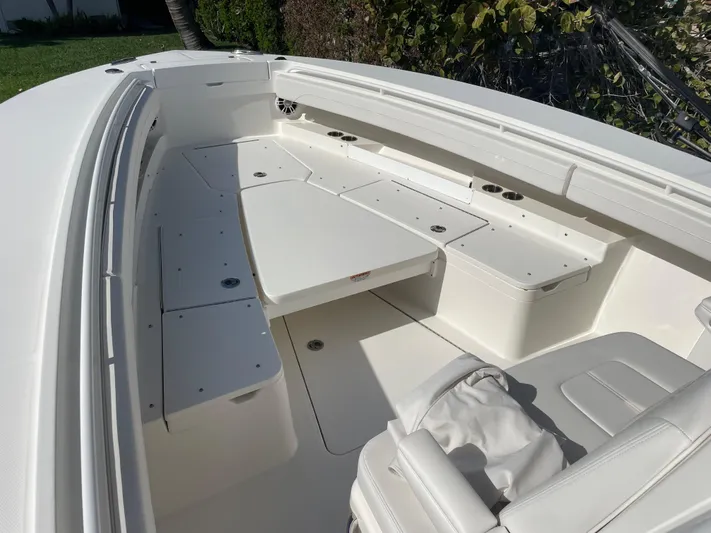  Yacht Photos Pics 2023 Regulator 31 boat interior with white seating and storage compartments.