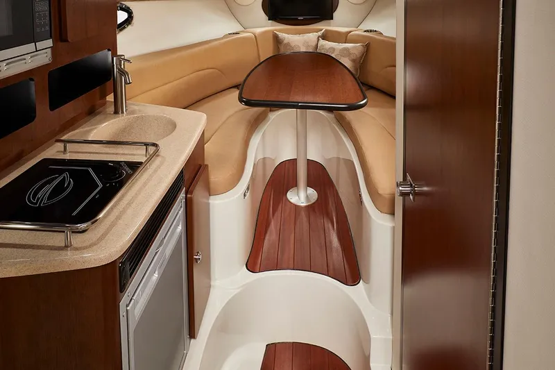  Yacht Photos Pics Manufacturer Provided Image: Interior of 2026 Crownline 280 CRX boat with kitchenette and seating area.
