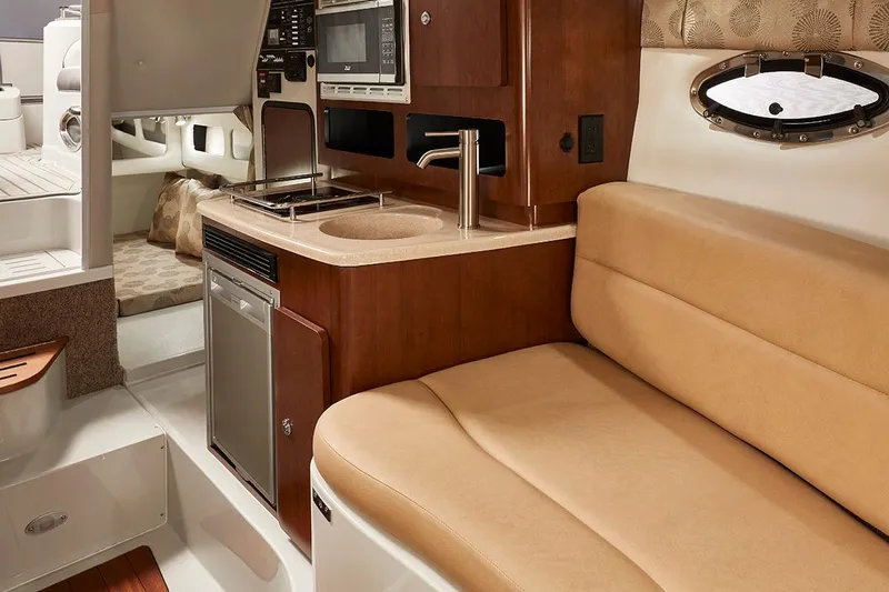  Yacht Photos Pics Manufacturer Provided Image: Interior of 2026 Crownline 280 CRX boat with kitchenette and seating area.