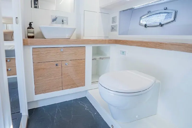  Yacht Photos Pics Luxurious bathroom in 2024 Rio Yachts Daytona 50 with modern fixtures and wood accents.