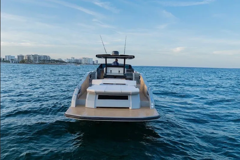  Yacht Photos Pics 2024 Rio Yachts Daytona 50 cruising on open water with city skyline in background.