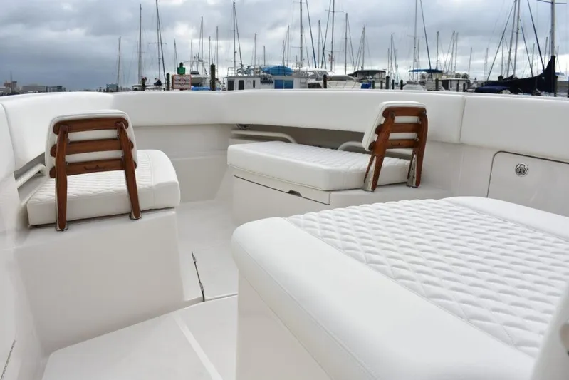  Yacht Photos Pics Luxurious seating on 2019 Jupiter 34 HFS boat, docked with sailboats in background.