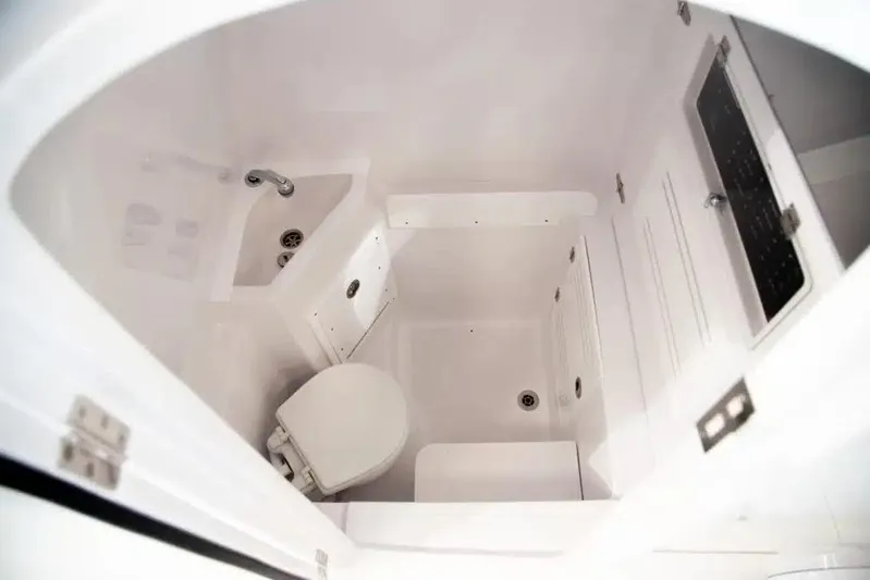  Yacht Photos Pics Compact bathroom in 2019 Jupiter 34 HFS boat, featuring toilet and sink.