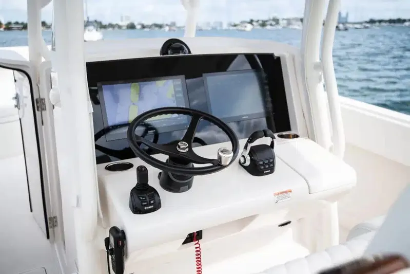  Yacht Photos Pics 2019 Jupiter 34 HFS boat helm with steering wheel, navigation screens, and controls on open water.