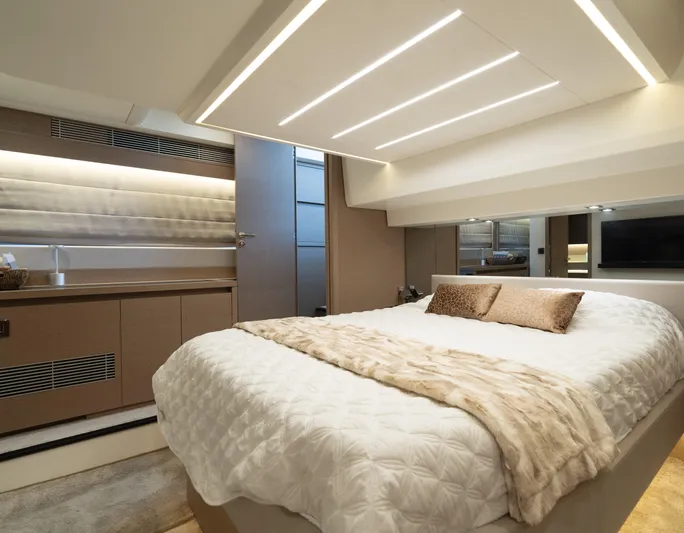 Motivated Seller Yacht Photos Pics Luxurious bedroom interior of 2019 Prestige 520 Flybridge yacht with modern lighting.