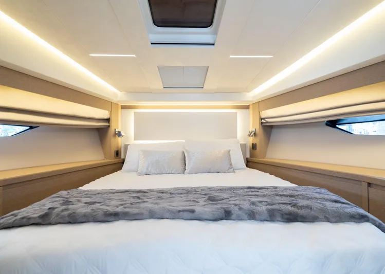 Motivated Seller Yacht Photos Pics Luxurious bedroom in 2019 Prestige 520 Flybridge yacht with modern lighting and cozy bedding.