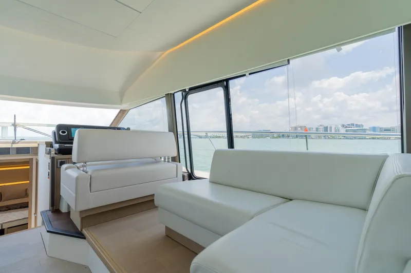 Motivated Seller Yacht Photos Pics Interior of 2019 Prestige 520 Flybridge yacht with white leather seating and panoramic windows.