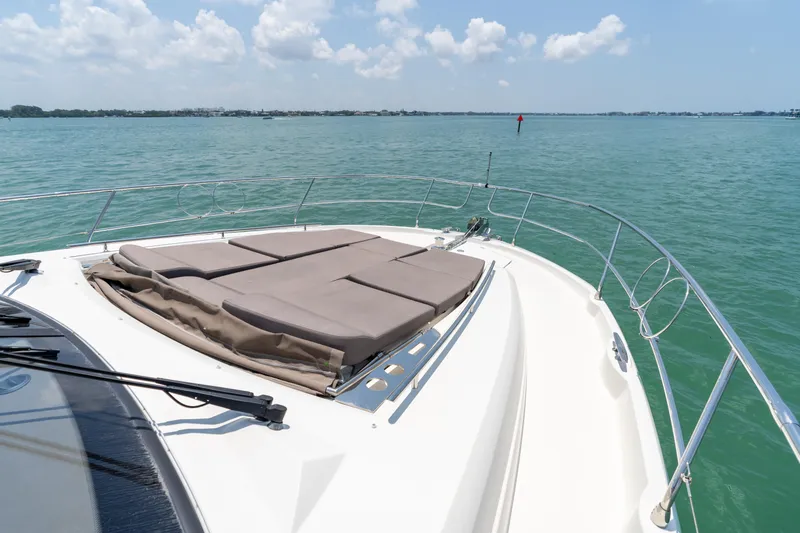 Motivated Seller Yacht Photos Pics Prestige 520 Flybridge 2019 yacht bow with sun pads on calm water.