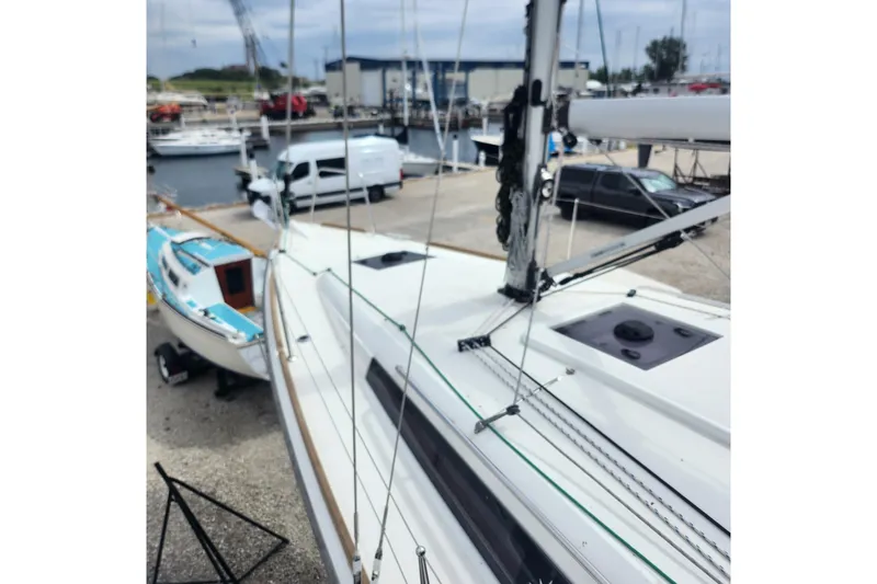  Yacht Photos Pics 2023 Jeanneau Sun Odyssey 349 sailboat docked at a marina, showcasing its sleek design.