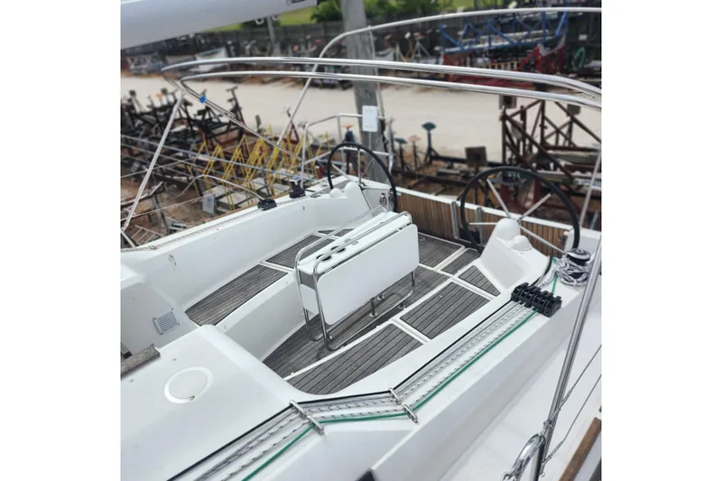  Yacht Photos Pics 2023 Jeanneau Sun Odyssey 349 yacht cockpit with dual steering wheels and teak flooring.