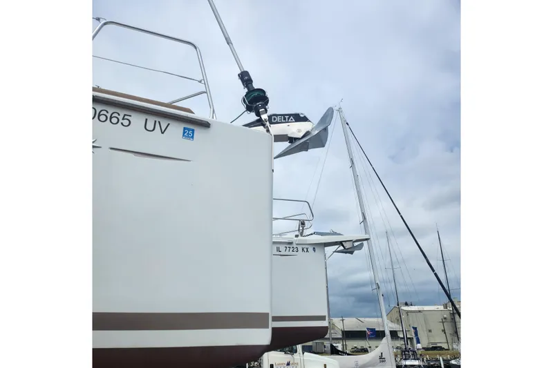 Yacht Photos Pics 2023 Jeanneau Sun Odyssey 349 sailboats docked under cloudy skies.