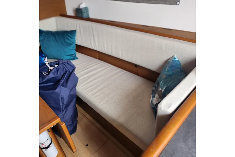  Yacht Photos Pics Interior of 2023 Jeanneau Sun Odyssey 349 with cozy seating and cushions.