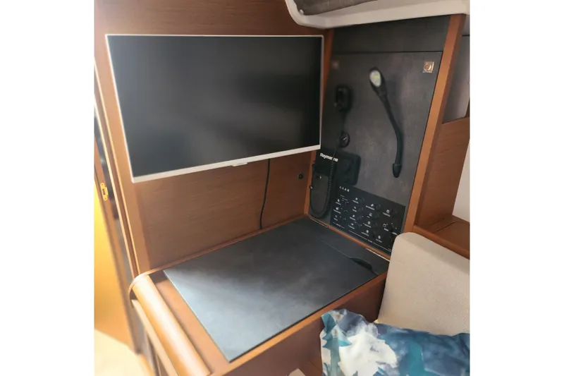  Yacht Photos Pics Interior of 2023 Jeanneau Sun Odyssey 349 yacht with navigation equipment and screen.