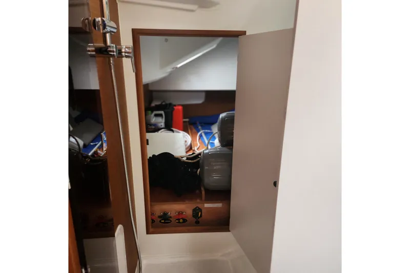  Yacht Photos Pics Interior view of 2023 Jeanneau Sun Odyssey 349 sailboat cabin with storage area.