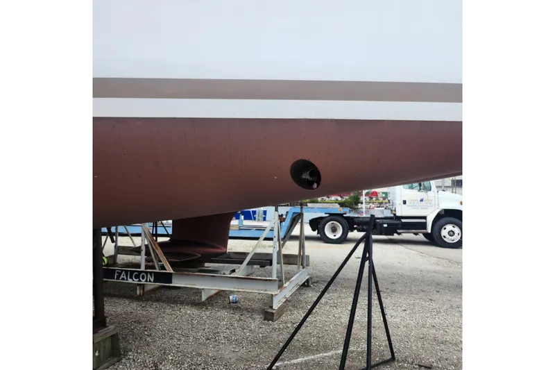  Yacht Photos Pics 2023 Jeanneau Sun Odyssey 349 hull on stand, showcasing propeller and keel.