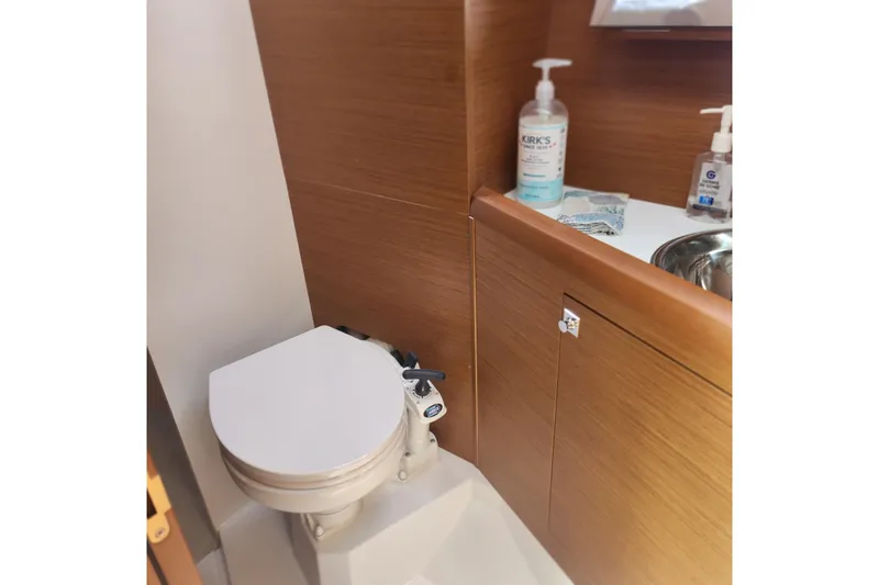  Yacht Photos Pics Bathroom interior of 2023 Jeanneau Sun Odyssey 349 yacht, featuring toilet and sink.