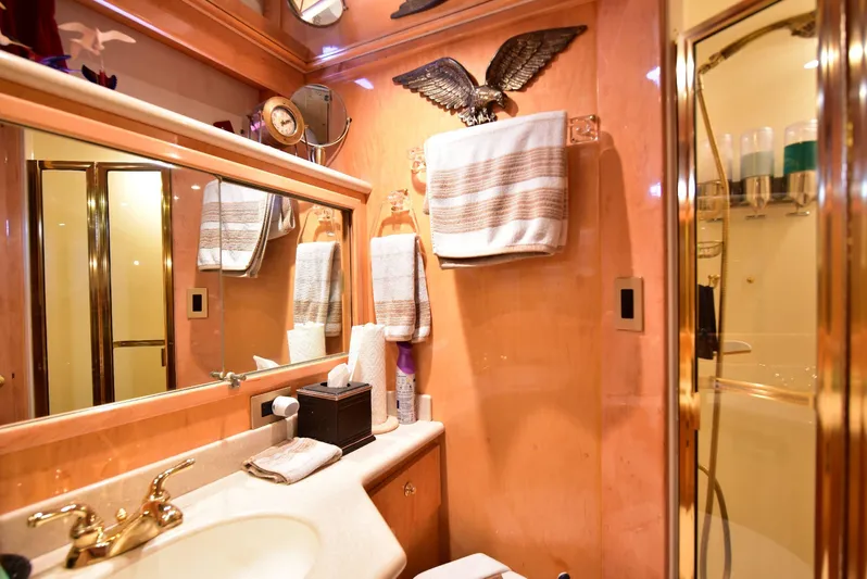 Next Chapter Yacht Photos Pics Luxurious 2004 Navigator Rival yacht bathroom with elegant fixtures and decor.