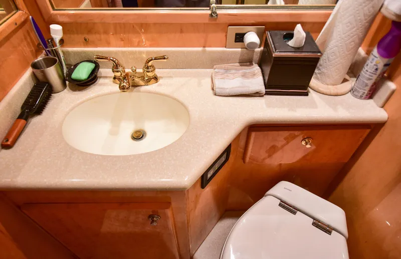 Next Chapter Yacht Photos Pics Luxurious 2004 Navigator Rival bathroom with elegant sink and gold faucet.