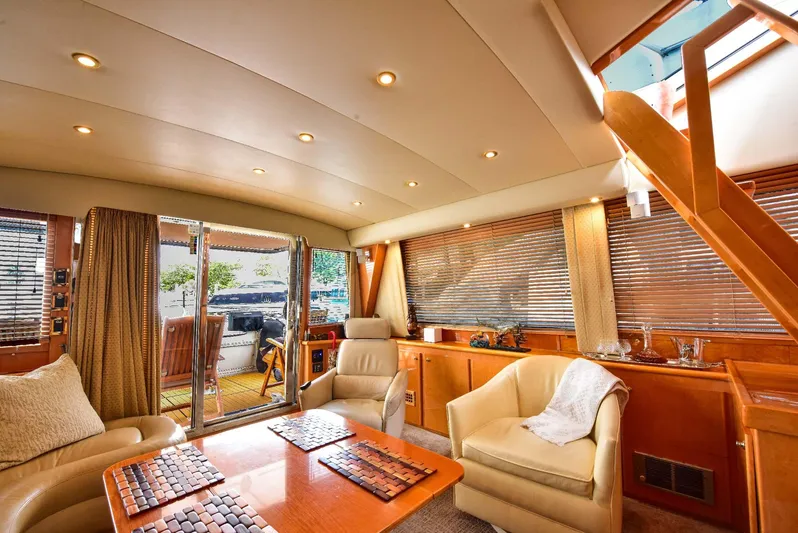 Next Chapter Yacht Photos Pics Luxurious 2004 Navigator Rival yacht interior with elegant seating and wooden accents.