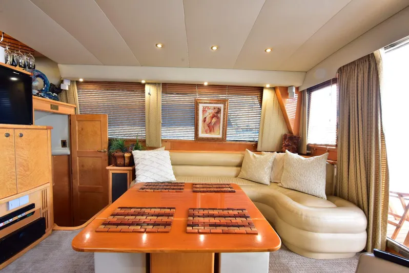 Next Chapter Yacht Photos Pics Luxurious 2004 Navigator Rival yacht interior with elegant seating and wooden accents.