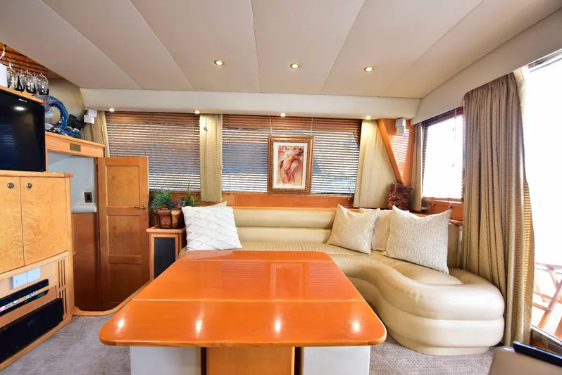 Next Chapter Yacht Photos Pics Luxurious 2004 Navigator Rival yacht interior with plush seating and elegant wood finishes.