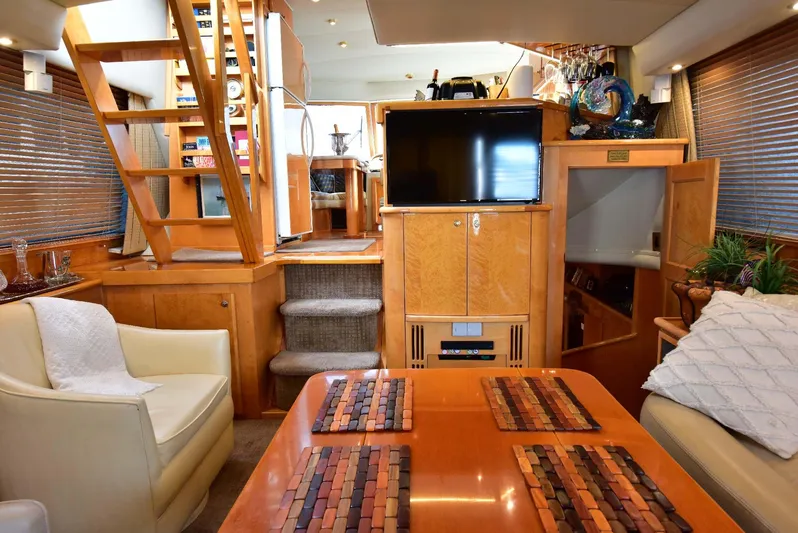 Next Chapter Yacht Photos Pics Luxurious 2004 Navigator Rival yacht interior with wood finishes and modern amenities.