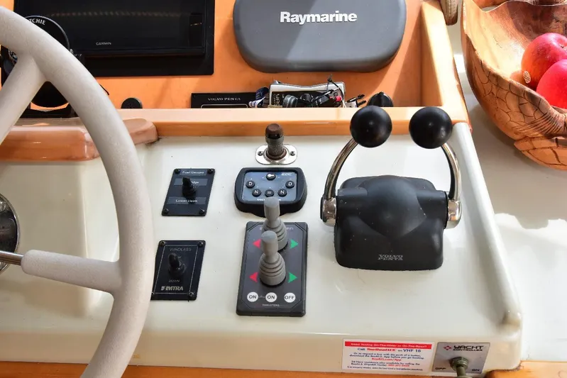 Next Chapter Yacht Photos Pics 2004 Navigator Rival boat control panel with steering wheel and navigation equipment.