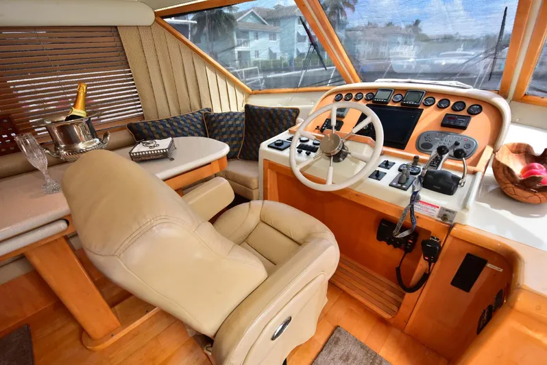 Next Chapter Yacht Photos Pics Luxurious 2004 Navigator Rival yacht interior with leather seating and elegant control panel.