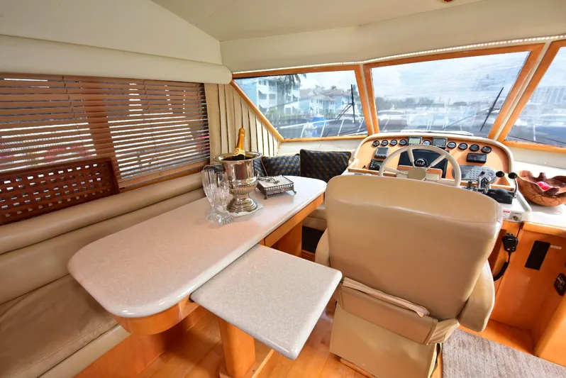 Next Chapter Yacht Photos Pics Luxurious 2004 Navigator Rival yacht interior with helm, dining area, and elegant decor.