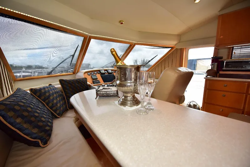 Next Chapter Yacht Photos Pics Luxurious 2004 Navigator Rival yacht interior with champagne and glasses on table.